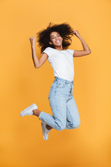 Full length portrait of a cheerful young african woman