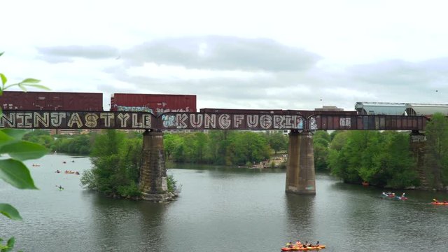 A train rides on top of graffiti in Austin, Texas.