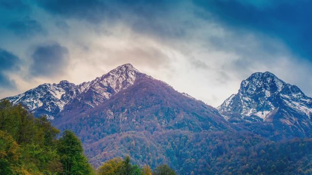 Cinemagraph of an autumn mountain scene zooming in to a cloudscape forming over the ridgline