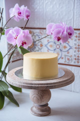 Naked wedding birthday cake. Rustic layer homemade cake with cream. Dessert decorated with chocolate and fruits. Selective focus. 