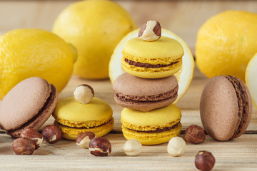 Yellow and brown french macarons with lemon and hazelnuts
