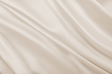 Fototapeta na wymiar Smooth elegant golden silk or satin luxury cloth texture as wedding background. Luxurious Christmas background or New Year background design. In Sepia toned. Retro style