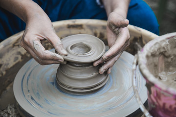 Closed up hands man using mechanic pottery made earthenware.