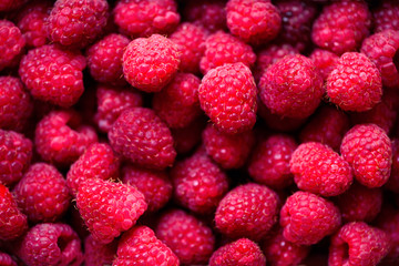 Fresh raspberries background with copy space. Top view, close up. Summer, vitamin, vegan, vegetarian concept. Healthy food. Macro of berries