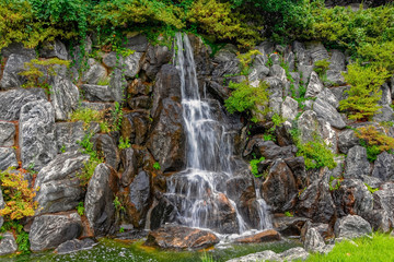 Fototapeta premium Small waterfall in public city park.