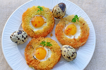Egg in a basket with quail eggs and saffron top view