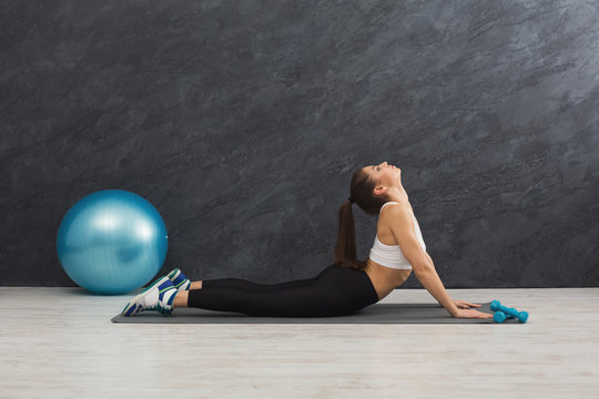 Fitness woman stretching indoors