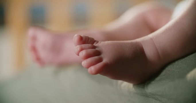 4k, newborn baby's legs close-up, slow motion