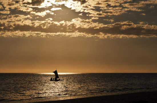 Silhouette of a boat (fishing pirogue) at the sea. Madagascar