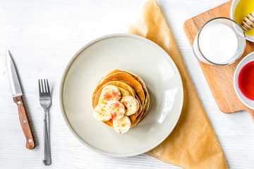 cooked pancake on plate top view at wooden background