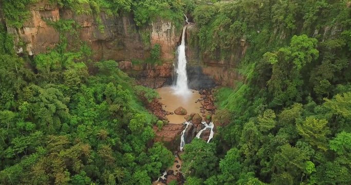 Exotic aerial view of Cimarinjung waterfall and green trees at Ciletuh Geopark, Sukabumi, West Java, Indonesia. Shot in 4k resolution