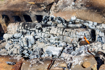 Ash and flame in bonfire. Barbecue campfire concept. Tourism and fireplace background. Charcoal and burn firewood. 