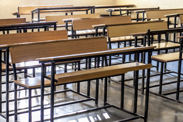 Close up of wooden empty school studying benches or desk. Concept of back to school.