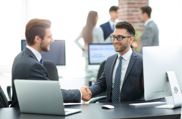 Fototapeta premium Successful managers shaking hands after closing deal in office
