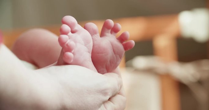 4k, a newborn baby holds a close-up in the mother's hands, slow motion