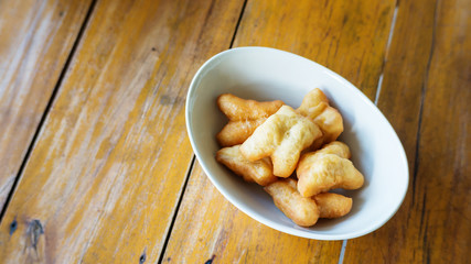 Chinese donut or Chinese breadstick on a wooden table for a breakfast.