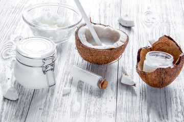 organic cosmetics with coconut on wooden background close up