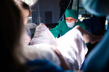Doctor examining pregnant woman during delivery