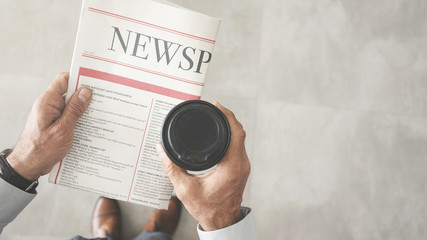 Man reading newspaper high angle view