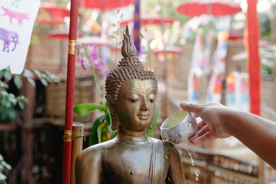 Sprinkle water onto a Buddha image. Songkran festival in thailand.