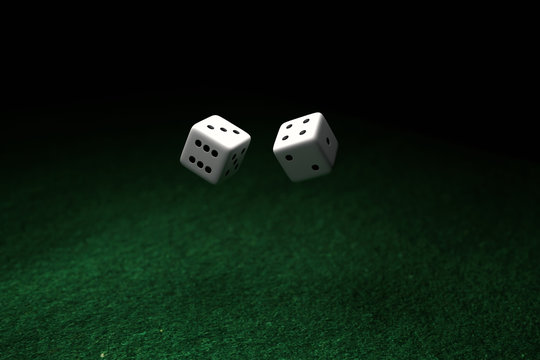 Pair of Dices floating on air, over green felt and black background