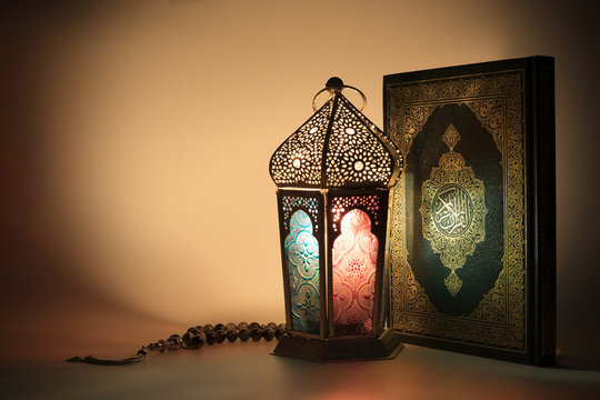 Colored lantern with Muslims holy book "Quran" with special light effects  Stock Photo | Adobe Stock