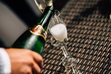 pour champagne into a glass