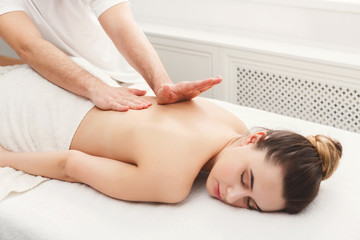 Obraz na płótnie Canvas Closeup of hands massaging female back