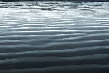 Obraz premium Wet sand patterns on beach, Cox Bay, Pacific Rim National Park Reserve, Vancouver Island, British Columbia, Canada