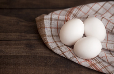 Farm Fresh White Chicken Eggs on a Dark Wood Table