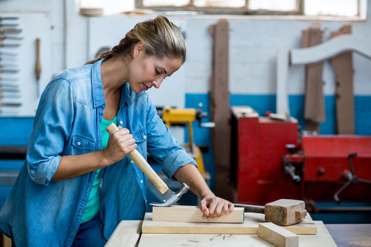 Female carpenter using a hammer