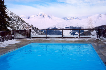Outdoor pool and mountain slopes in the Alps in France
