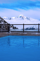 Outdoor pool and mountain slopes in the Alps in France