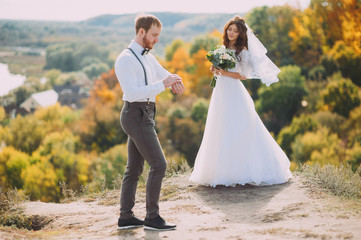 Bride and groom walking in nature. A stylish wedding. Love story. Rustic style.