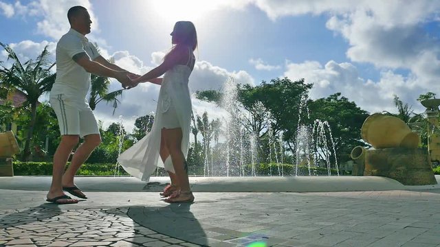 Footage of happy kissing couple near a hotel