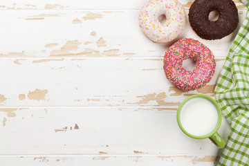Milk and donuts on wooden table