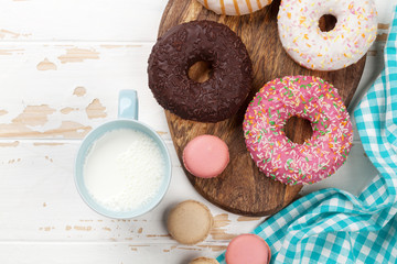 Milk and donuts on wooden table