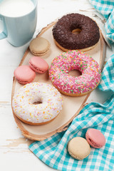 Milk and donuts on wooden table