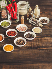Spices and herbs. Variety of spices and herbs on a wooden surface