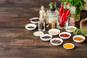 Spices and herbs. Variety of spices and herbs on a wooden surface