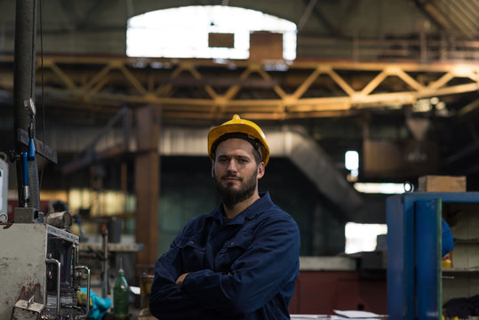 Portrait of confident technician standing with arms crossed