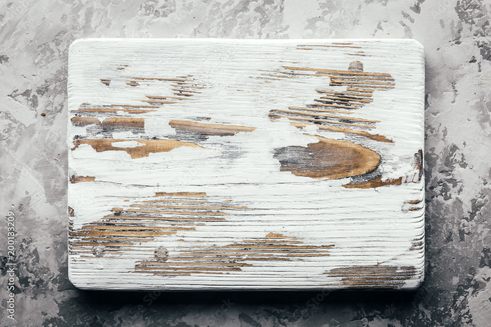 Wall mural Old rustic white wood board on rustic concrete table. Food photography