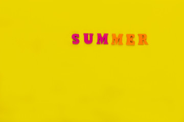 word summer of multicolored letters on bright yellow background