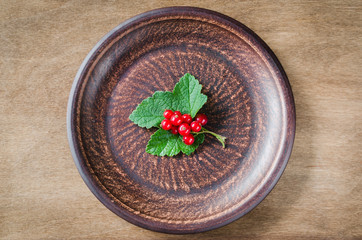Fresh ripe organic red currant in plate.
