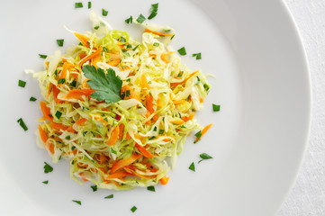 white cabbage salad with carrot and parsley