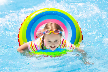 Child in swimming pool. Kids swim. Water play.