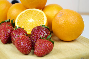 Strawberries and oranges in macro view