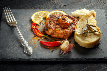 Beef steak with mashed potatoes, spices and sauce.