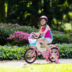 Fototapeta premium Child riding bike. Kid on bicycle.