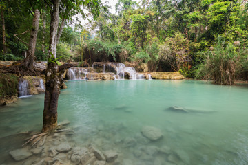 Beautiful view of small cascades and a shallow pool at the Tat Kuang Si Waterfalls near Luang Prabang in Laos.